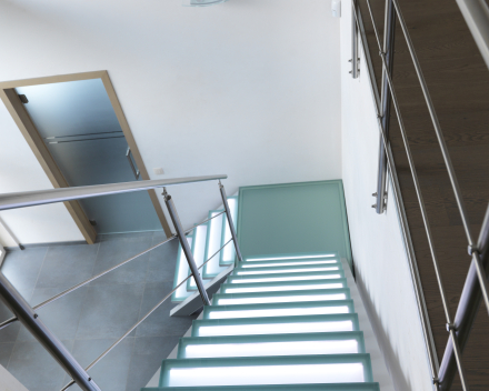 Illuminated stair with glass treads at Devloo in Eeklo